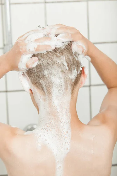 Close up on back of head covered with shampoo