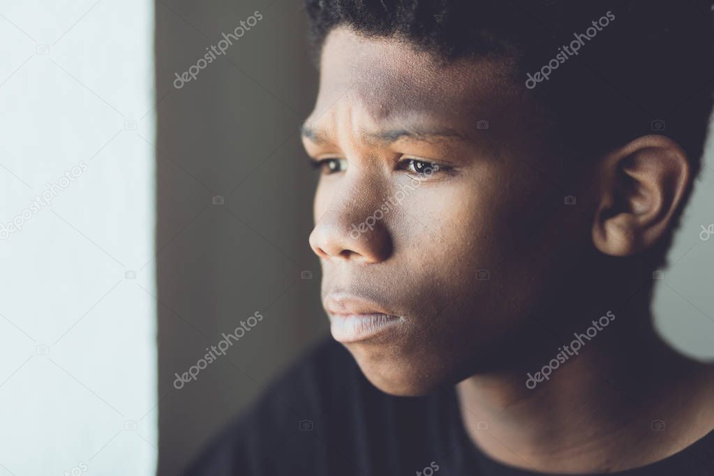 Faded retro portrait of a worried African boy