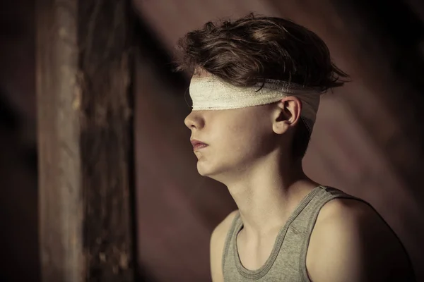 Teenage boy tied up in a blindfold — Stock Photo, Image