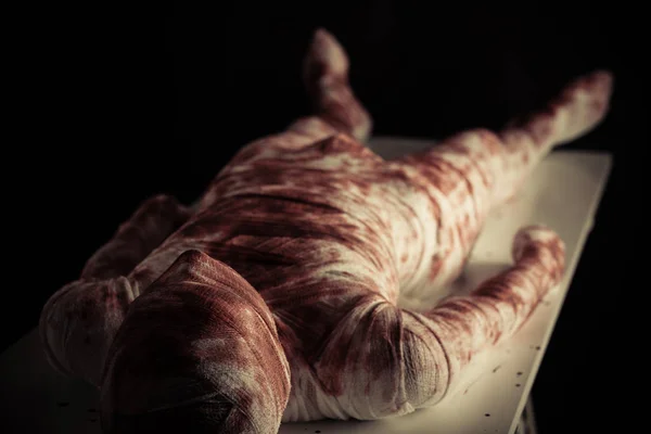 Jonge bloedige mummie weergegeven op witte tafel — Stockfoto