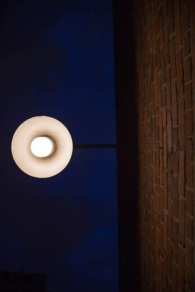 Bright lantern brick wall night