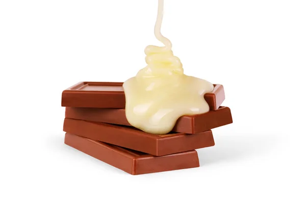 Sweet milk sauce is poured on a chocolate bar — Stock Photo, Image