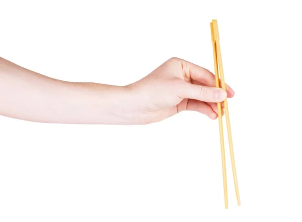 Palillos con mano sobre fondo blanco aislado — Foto de Stock