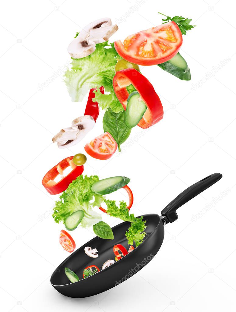 Fresh vegetables flying into a pan, isolated on white background