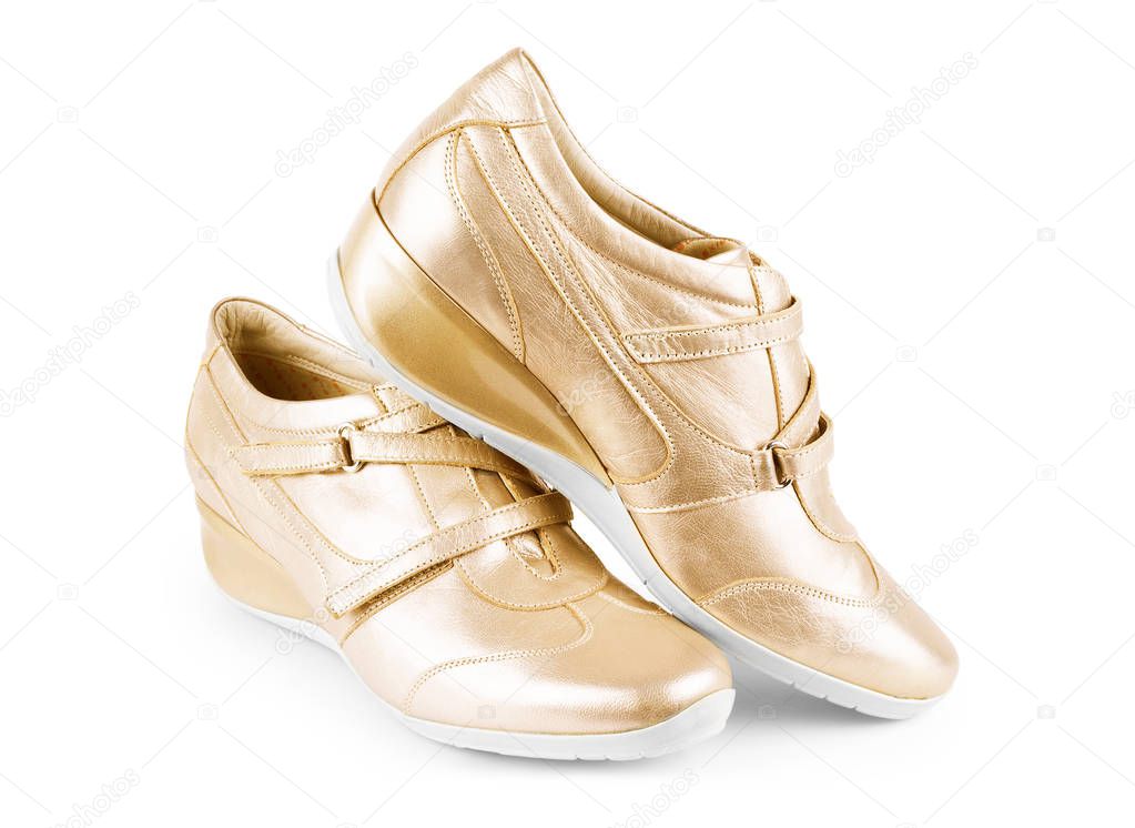 Golden sport shoes isolated on white background