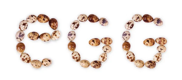 Ovos de codorna em forma de letra E sobre fundo branco — Fotografia de Stock