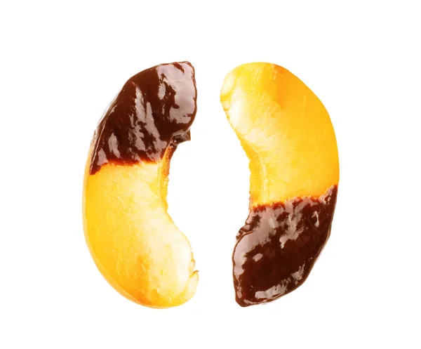 Slices of peach in chocolate on a white background — Stock Photo, Image
