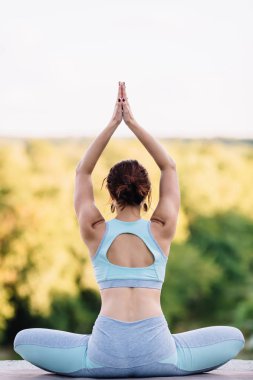 Parkta yoga egzersizi yapan güzel bir kadın.