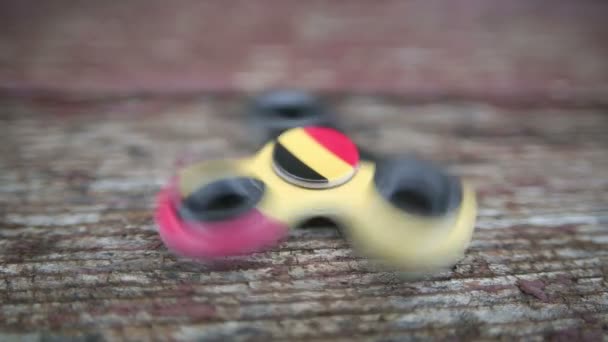 Fidget spinner close-up wiev on wooden background — Stock Video