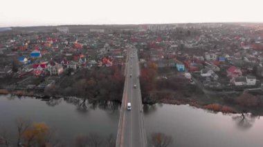 Nehir kenarındaki köprülerin ve küçük Avrupa kentindeki iki kilisenin hava görüntülerini sonbaharın sonlarına doğru geri çek.