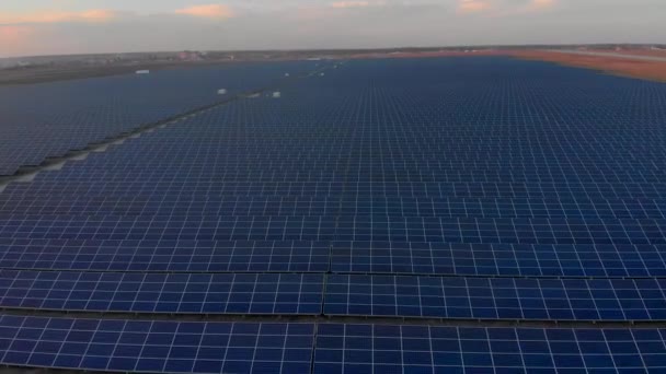 Aerial drone view into large solar panels at a solar farm. Solar cell power plants. footage video 4k. — Stock Video