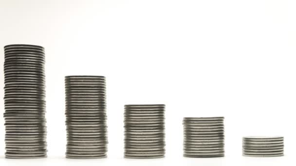 Silver coins on stacks are decrease on white background stop motion animation Stock Footage
