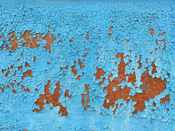 Rusty metal panel with cracked blue paint, corroded grunge metal background texture