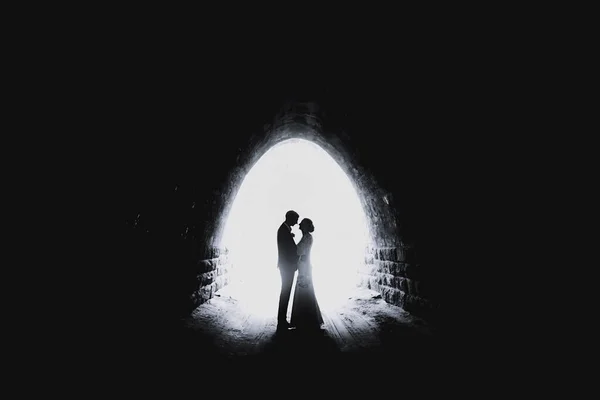 Couple and light in the end of the tunnel. Love and hope concept, soft focus