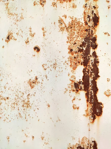 Corroded metal background. Rusted white painted metal wall. Rusty metal background with streaks of rust. Rust stains. The metal surface rusted spots. Rystycorrosion.