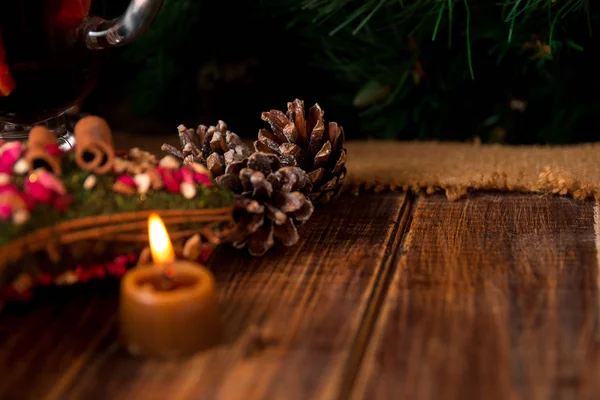 テーブルの上のクリスマスの装飾。キャンドル、マツ円錐形の木製の背景。新しい年. — ストック写真