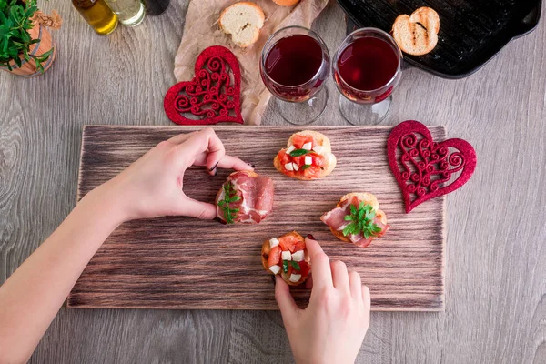 Bruschetta. Woman is cooking romantic dinner. Top view. Valentine Day. Love.