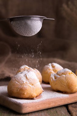 Şeker profiterol buzlanma ile dekorasyon işlemi. Rustik tarzı.