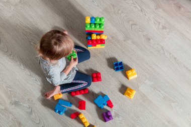 Eğlenceli ve parlak plastik inşaat yapı olan kız çocuk