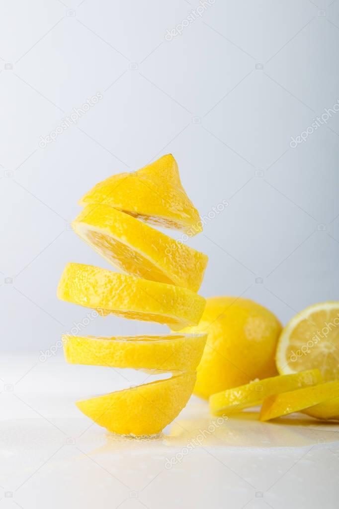 Flying lemon. Sliced lemon on white background. Levity fruit floating in the air.
