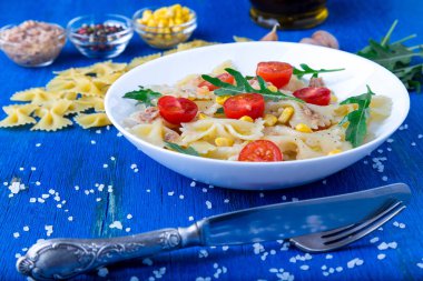 Kiraz domates, ton balığı, Mısır ve roka ile makarna salatası. Yakın çekim.