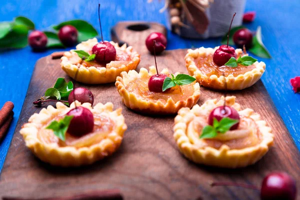 Karamel küçük ahşap tahta ve rustik arka plan mavi tarts elma. Cennet elması ile Fransız tatin. Yakın çekim.