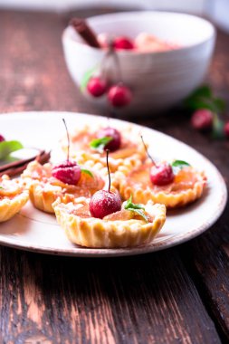 Karamel küçük tarts beyaz plaka ve kahverengi rustik zemin üzerinde Apple. Cennet elması ile Fransız tatin.