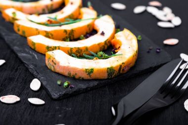 Siyah arka plan üzerine siyah arduvaz plaka üzerinde ızgara kabak