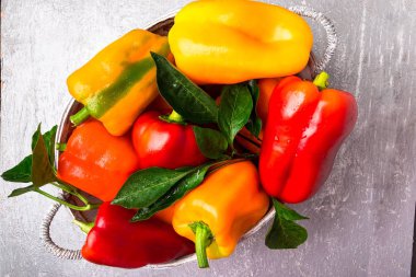 Kırmızı ve sarı biber gri sepet içinde. Sağlıklı organik sebze. Üstten Görünüm. 