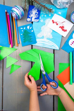 Çocuk el karton el yapımı Noel oyuncaklar yapacaklar. Çocuk DIY kavramı.