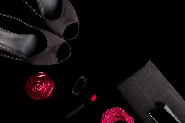 Fashion Lady Accessories Set. Black and pink. Minimal. Shoes, bracelet, perfume, lipstick and bag on black background. Flat lay.