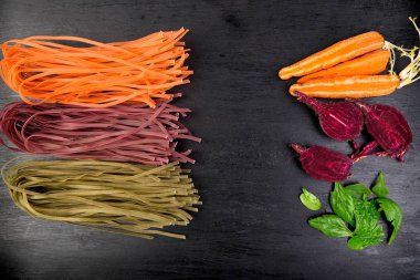 Pancar, havuç ve ıspanak çiğ sebze vejetaryen makarna renkli. Düz yatıyordu. Uzay kopyalayın. Üstten Görünüm. Çerçeve.