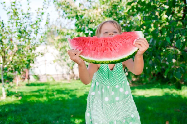 Little girl hide her face by big slice watermelon. Summer. Outdoor. Unrecognizable child. Giving, Shares