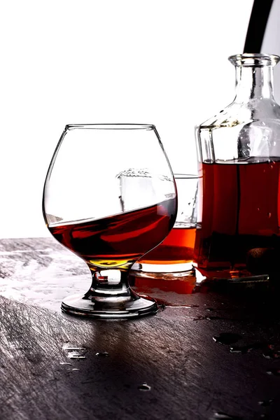 Glass of splash whiskey with bottle. — Stock Photo, Image