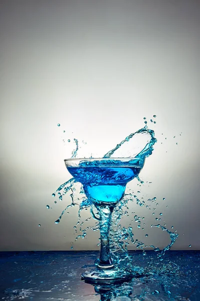 Glass with blue champagne or cocktail. Levitation — Stock Photo, Image