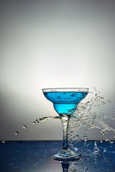 Glass with blue champagne or cocktail. Levitation — Stock Photo, Image