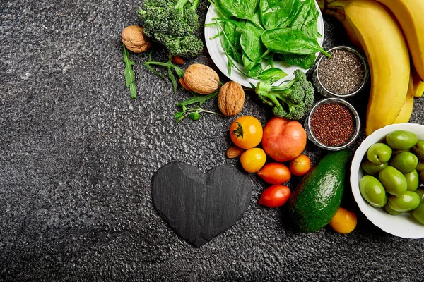 Selection of food that is good  and healthy for the heart on dark grey background. Top view, flat lay, Copy space.