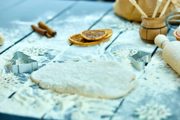 Christmas baking background. Raw dough for Christmas cookies. Kitchen utensils and ingredients for cooking baking