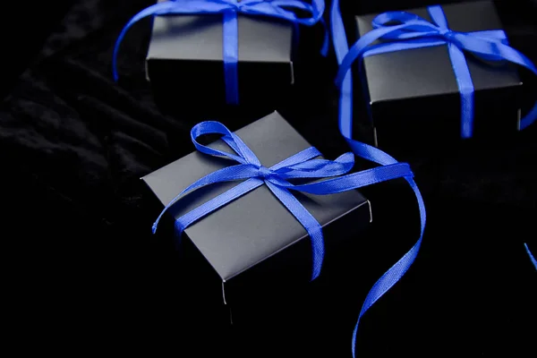 Luxury black gift boxes with green ribbon Stock Photo by bondarillia