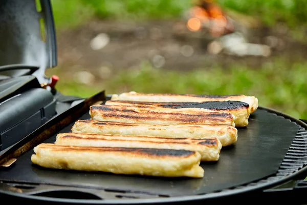 Grilled cheese puff pastry on the grill gas outdoor.