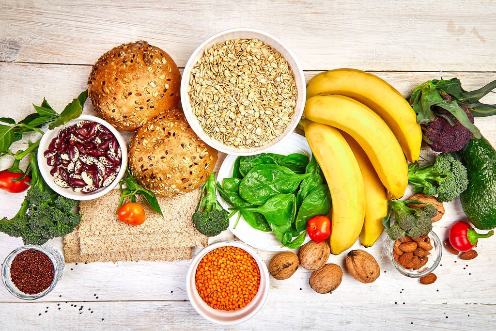 Selection food rich in fiber on white wooden background