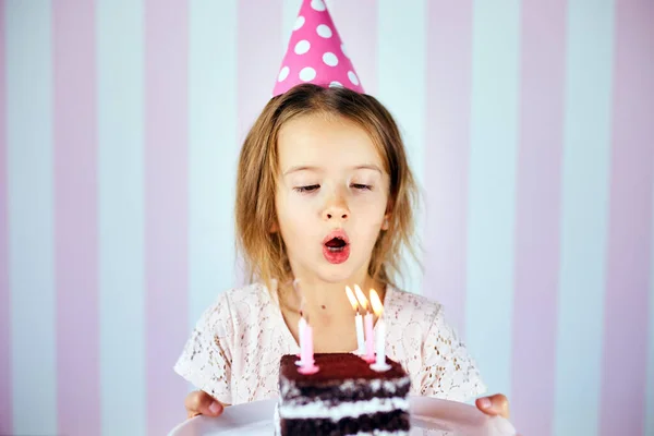 Little Girl Pink Cap Blowing Out Candles Birthday Chocolate Cake Royalty Free Stock Images