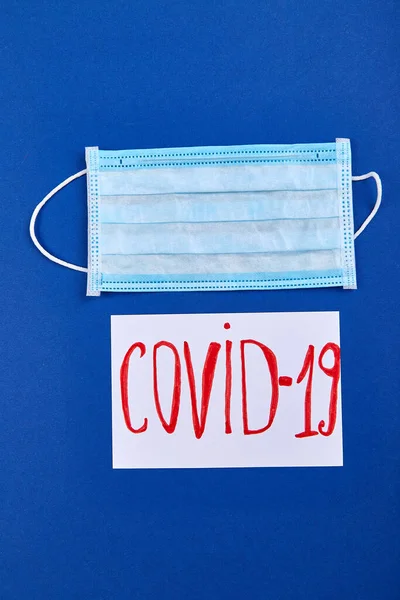 Coronavirus Phrase Text Flat Lay Protective Face Mask Blue Background — Stock Photo, Image