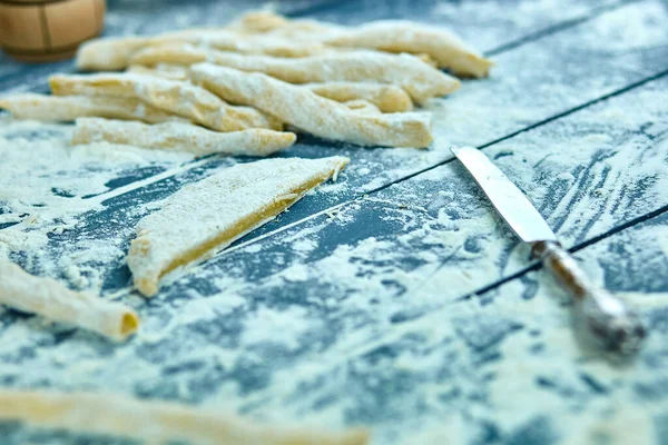 Closeup process making homemade pasta. Fresh dough for italian traditional pasta to thin ribbon. Italian cuisine recipe. Home cuisine.