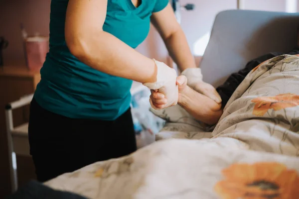 old patient on bed with doctor holding hands for nursing, medical health care