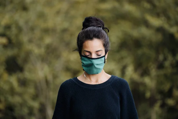 Foto de una joven en el bosque con una máscara facial — Foto de Stock