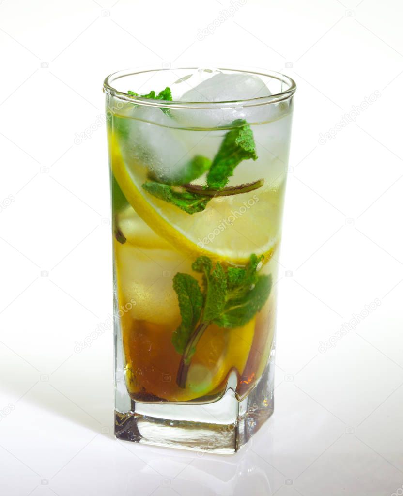drops of rose on a glass of cold drink with ice, lemon and mint on a white background