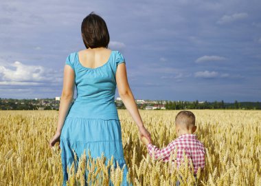  Genç anne oğlu ile bir buğday sahada oynuyor. Microstock fotoğraf