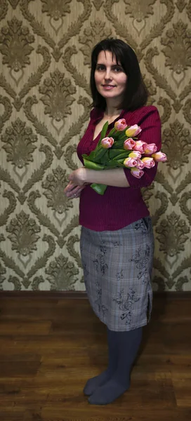 girl with a bouquet of tulips on a woman\'s day March 8 photo for a micro-stock