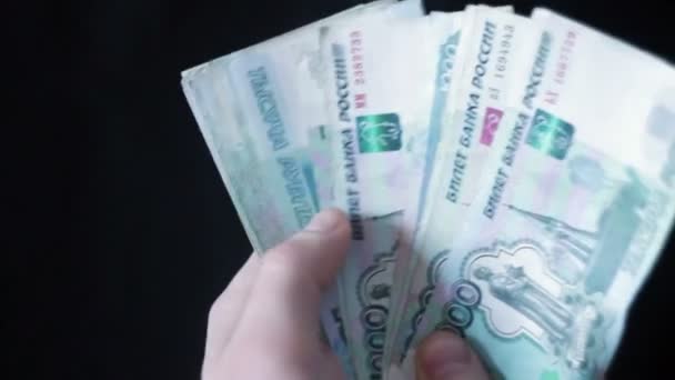 Male hands holding a fan of Russian rubles — Stock Video